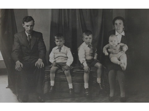 Mr Eric Kelly with his parents and brothers. From left to right: Mr Kellyâs father, brother Paul, Mr Eric Kelly as a child and his brother Murray sitting on his motherâs lap. Photograph dated 1946-1947