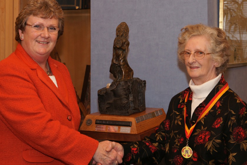 Mrs Joan Caine receiving the Reih Bleeaney Vanannan from the Hon Anne Craine, MHK