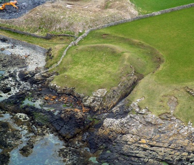 This aerial view of the site shows the gulley to the side. It is possible that the seaward side of the site has eroded over the years.