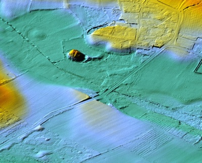 A LiDAR image of the site. The mound is clearly visible as is the remains of what might have been a causeway leading to the moat and drawbridge. LiDAR (Light Detection and Ranging) is a method of scanning the ground from aircraft using lasers. This image is by courtesy of Dave Martin from materials supplied by the mapping section of the Isle of Man Government's Department of Infrastructure (under licence ACA-1040). 
